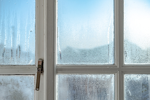 cold room interior looking out onto water condensation formed on interior windows during early winter.